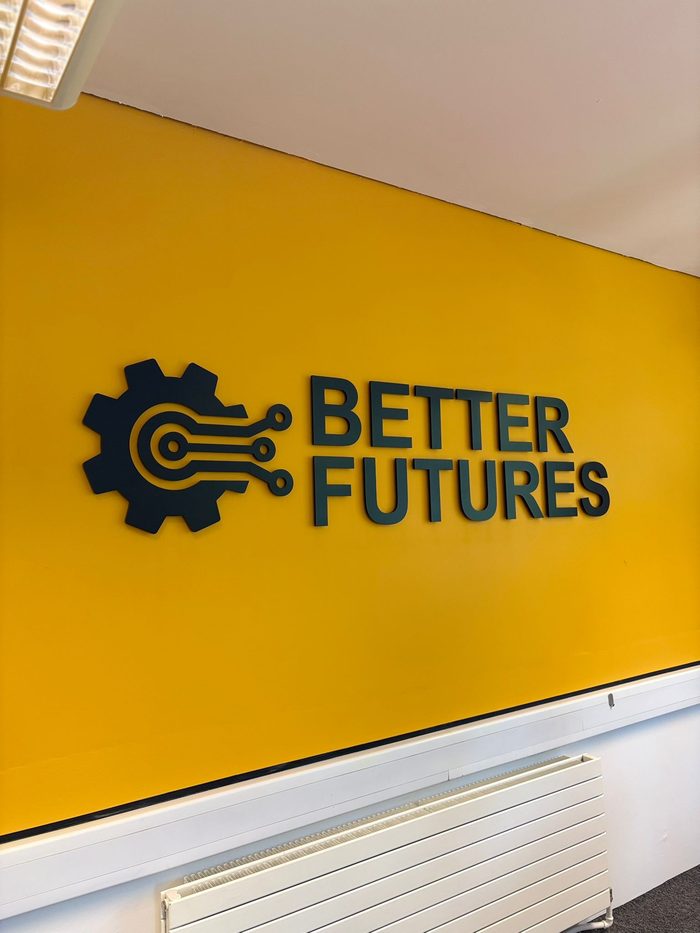 Dimensional laser-cut acrylic 3D letters mounted on a shopfront wall